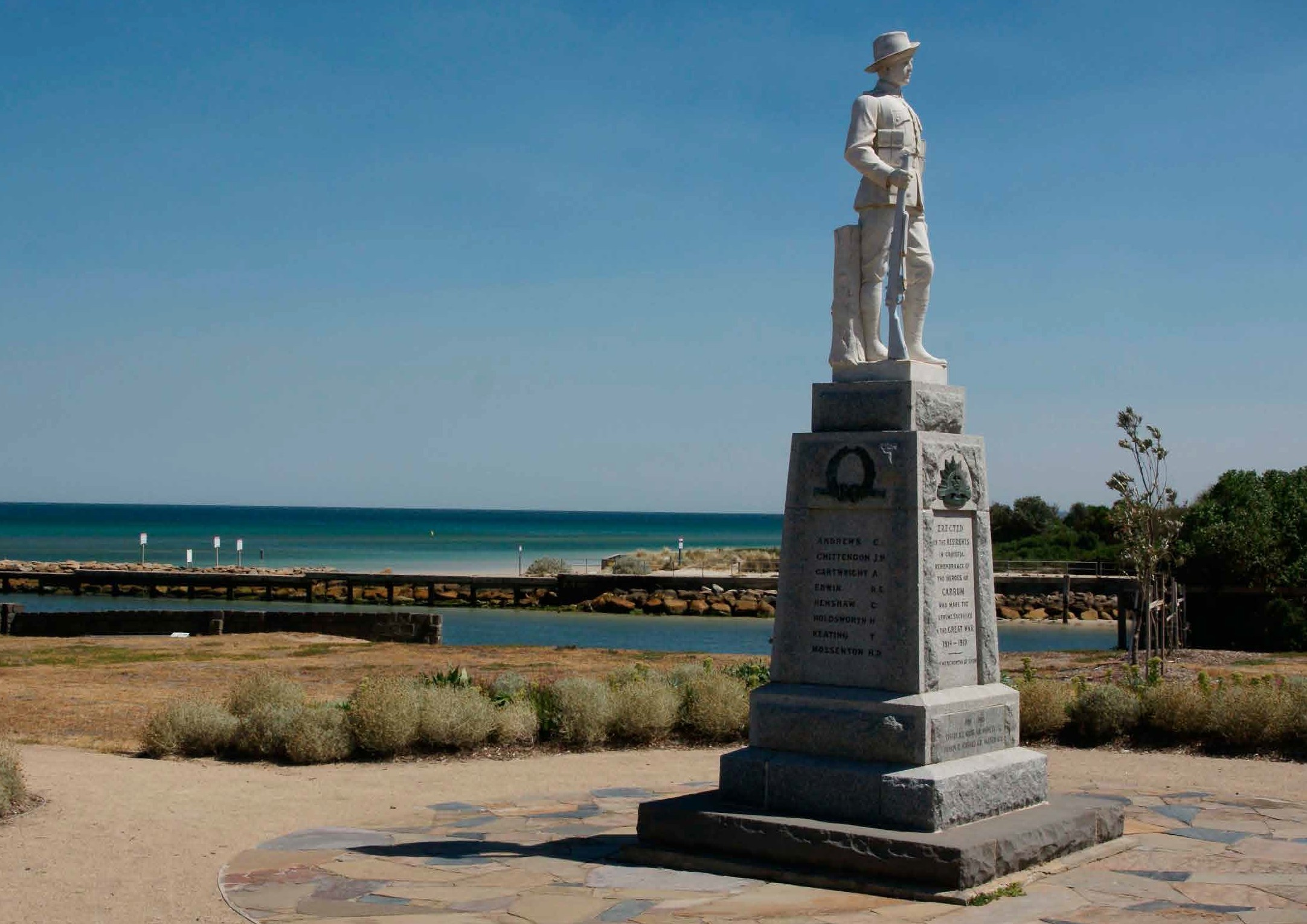 memorial statue overlooking a bay